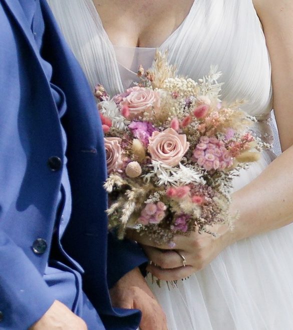 Hochzeitsdekoration mit einem roten Teppich, geschmückten Bänken und einem Altar.